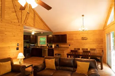 a living room with a couch and a dining room at Deer Crest Cabin 5Bedroom near JFBB ski area/Lake in Albrightsville