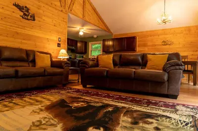 a living room with two leather couches and a rug at Deer Crest Cabin 5Bedroom near JFBB ski area/Lake in Albrightsville