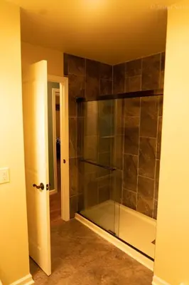 a bathroom with a shower with a glass door at Deer Crest Cabin 5Bedroom near JFBB ski area/Lake in Albrightsville