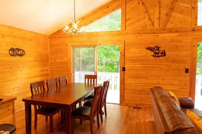 a dining room with a wooden table and chairs at Deer Crest Cabin 5Bedroom near JFBB ski area/Lake in Albrightsville