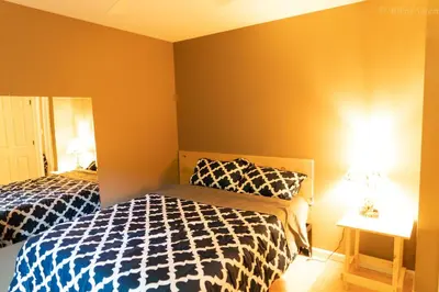 a bedroom with two beds and a table with lamps at Deer Crest Cabin 5Bedroom near JFBB ski area/Lake in Albrightsville