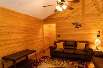 a living room with a couch and a ceiling fan at Deer Crest Cabin 5Bedroom near JFBB ski area/Lake in Albrightsville