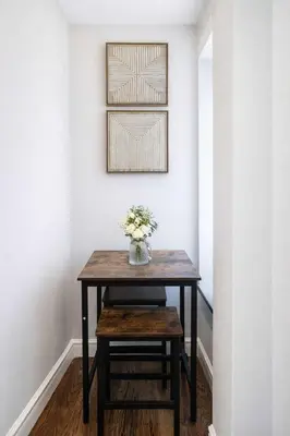 a table in a hallway with a vase of flowers on it at Bold Manhattan Base in Prime Nolita in New York