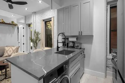 a kitchen with a sink and a dishwasher at Modern Nolita Hideaway in New York