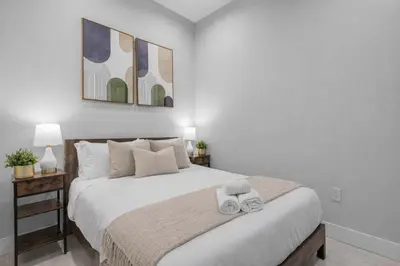 a bedroom with a bed with two towels on it at Modern Nolita Hideaway in New York