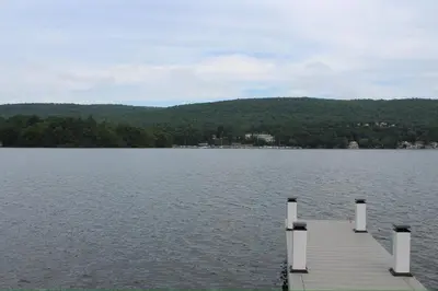 a dock in the middle of a lake at Lakefront Haven on Greenwood Lake in West Milford