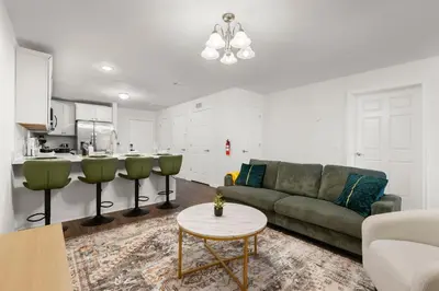 a living room with a couch and a table at Traveler Haven XL NYC & NWK with free parking in Newark
