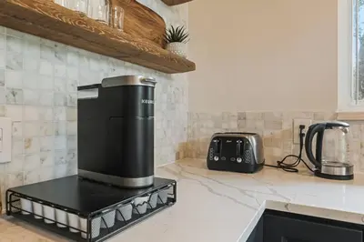 a coffee maker on a counter in a kitchen at Pocono Chalet with Sauna/Hot Tub/Firepit/10+ Beds in Long Pond