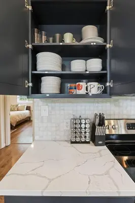 a kitchen with a counter top with plates and dishes at Pocono Chalet with Sauna/Hot Tub/Firepit/10+ Beds in Long Pond