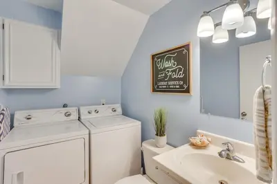 a bathroom with a washer and dryer and a sink at Family Retreat Near Hersheypark with Horse Farm View in Elizabethtown