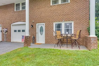 a table and chairs in front of a brick house at Family Retreat Near Hersheypark with Horse Farm View in Elizabethtown