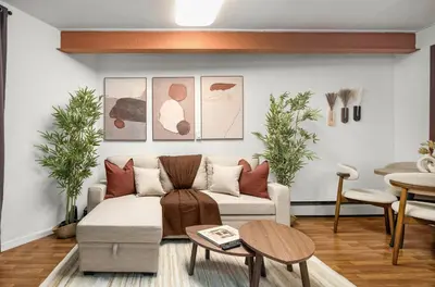 a living room with a couch and a table at Chic Modern Unit in NYC in Brooklyn