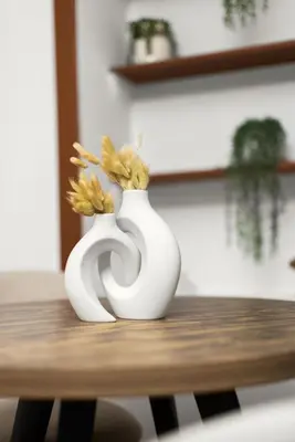 two white vases sitting on top of a wooden table at Chic Modern Unit in NYC in Brooklyn