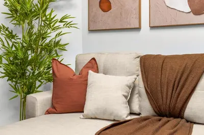 a living room with pillows on a couch at Chic Modern Unit in NYC in Brooklyn