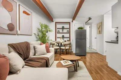 a living room with a couch and a table at Chic Modern Unit in NYC in Brooklyn