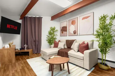 a living room with a couch and a table at Chic Modern Unit in NYC in Brooklyn