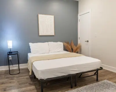 a bedroom with two beds and a blue wall at 4BR 3Bath Home WDParkingYard Sleeps 10 in Philadelphia
