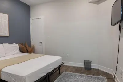 a bedroom with a bed and a flat screen tv at 4BR 3Bath Home WDParkingYard Sleeps 10 in Philadelphia