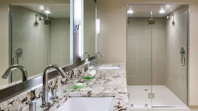 a bathroom with two sinks and a shower at Hyatt Regency Princeton in Princeton