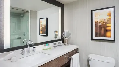 a bathroom with a sink and a toilet and a mirror at Hyatt Regency Princeton in Princeton
