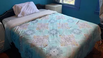 a bed with a quilt on it in a bedroom at 2218NColoradoC in Philadelphia