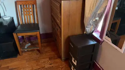 a room with a chair and a dresser and a mirror at 2218NColoradoC in Philadelphia