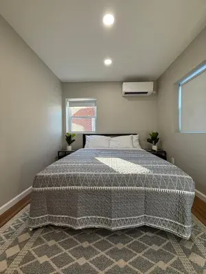 a bedroom with a large bed in a room at Cozy Cottages Flexible Stays in Wrightsville