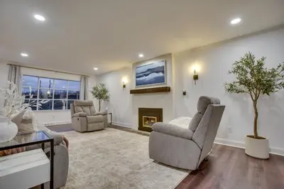 a living room with two chairs and a fireplace at Zook Manor with Hot tub Firepit and Game Room in Atglen