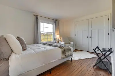 a white bedroom with a bed and a window at Zook Manor with Hot tub Firepit and Game Room in Atglen