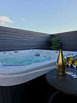 a hot tub with a table and glasses of wine at Curacao vs Ivory Coast, Lock in NOW! Sleeps 14 in Philadelphia