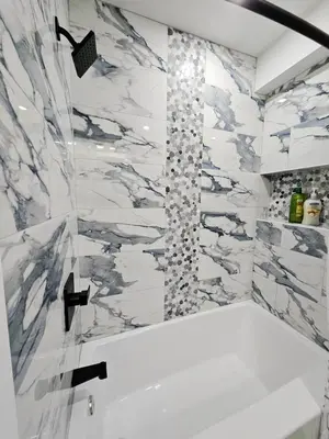 a bathroom with a shower with marble walls at Curacao vs Ivory Coast, Lock in NOW! Sleeps 14 in Philadelphia