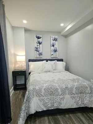 a bedroom with a bed and two paintings on the wall at Curacao vs Ivory Coast, Lock in NOW! Sleeps 14 in Philadelphia