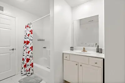 a white bathroom with a sink and a shower at 7 guests NYC-NWK Free parking in Newark