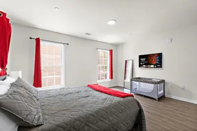 a bedroom with a bed and a desk in it at 7 guests NYC-NWK Free parking in Newark