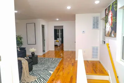 a living room with a couch and a rug at Modern Minimalist Lux Paradise in Newark
