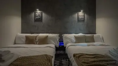 two twin beds in a room with at Luxury Lookout with NYC view, 2BR plus Free Parking, Sleeps 8, 20 Percent Off in East Orange