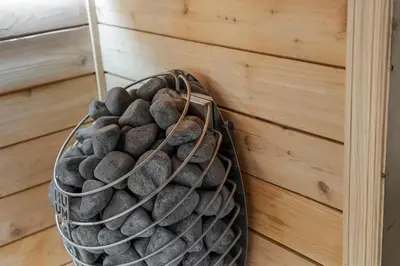 a basket of rocks hanging on a wall at Malkita Terra -Earthly Elegance in Woodbury