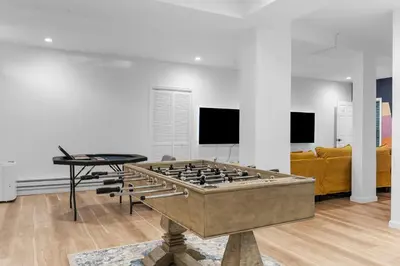 a living room with a large foosball table at Malkita Terra -Earthly Elegance in Woodbury