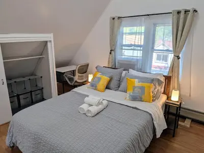 a bedroom with a bed with towels on it at Spacious duplex retreat in city w/ Parking nearby in Jersey City