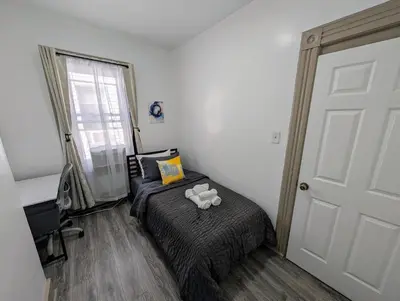 a bedroom with a bed with a teddy bear on it at Spacious duplex retreat in city w/ Parking nearby in Jersey City