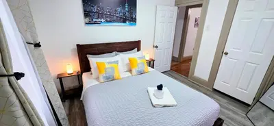 a bedroom with a bed with a tray on it at Spacious duplex retreat in city w/ Parking nearby in Jersey City