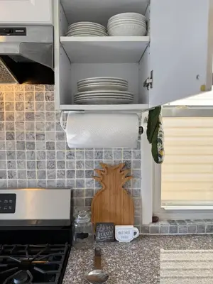 a kitchen counter with plates in a cupboard at Sunset Slopes in Jersey City