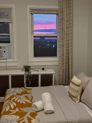 a bedroom with a bed with two towels on it at Sunset Slopes in Jersey City