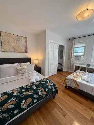 a bedroom with two beds and a window at Sunset Slopes in Jersey City