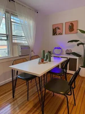 a table and chairs in a room with a table at Sunset Slopes in Jersey City