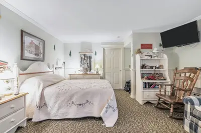 a bedroom with a bed and a tv on the wall at Quiet Getaway with Queen Bed & Wi-Fi in Clarks Summit