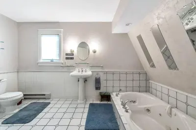 a bathroom with a tub and a sink and a toilet at Quiet Getaway with Queen Bed & Wi-Fi in Clarks Summit