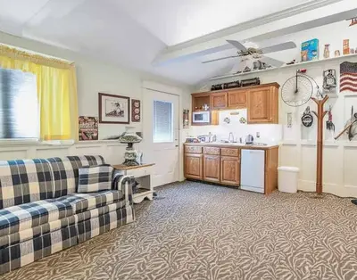 a living room with a couch and a kitchen at Quiet Getaway with Queen Bed & Wi-Fi in Clarks Summit
