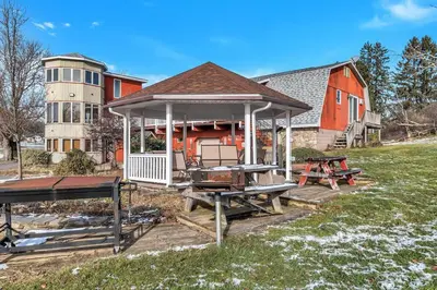 a gazebo in front of a red house at Quiet Getaway with Queen Bed & Wi-Fi in Clarks Summit