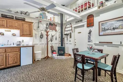 a kitchen with a table and chairs and a stove at Quiet Getaway with Queen Bed & Wi-Fi in Clarks Summit